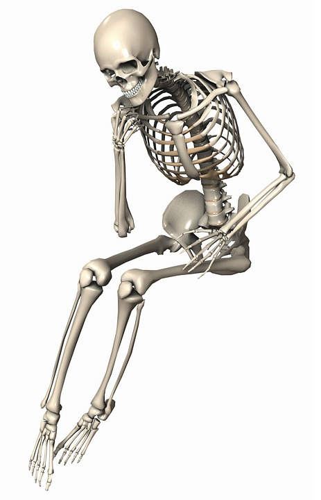 skeleton in a sitting position admiring the text
